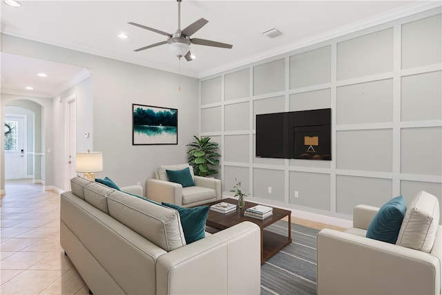 living room featuring light tile patterned flooring, crown molding, and ceiling fan