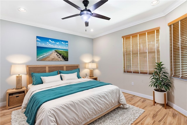 bedroom featuring ornamental molding, light hardwood / wood-style floors, and ceiling fan