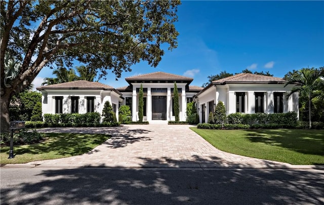 mediterranean / spanish-style house with a front yard