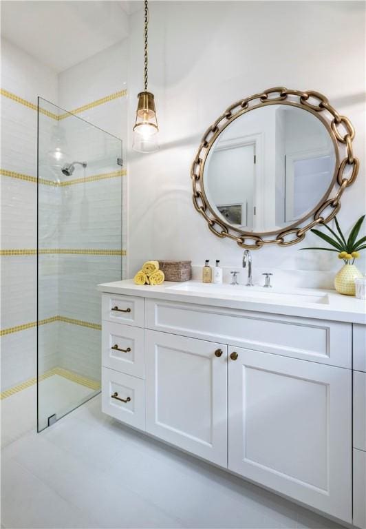 bathroom featuring vanity and tiled shower