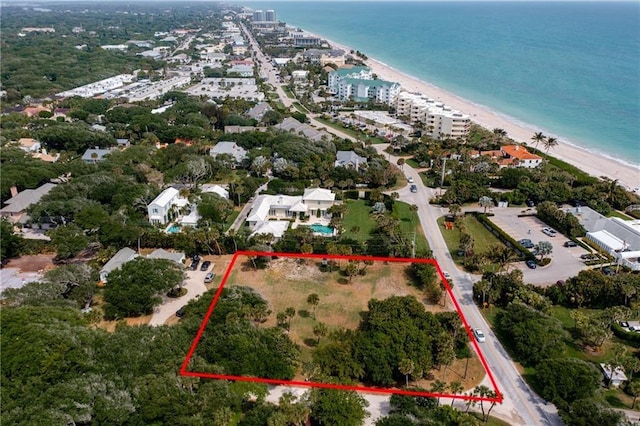 drone / aerial view featuring a water view and a beach view