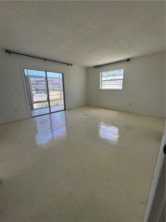 5 Vista Palm Ln Unit 105, Vero Beach, FL 32962 - spare room with concrete floors and a textured ceiling