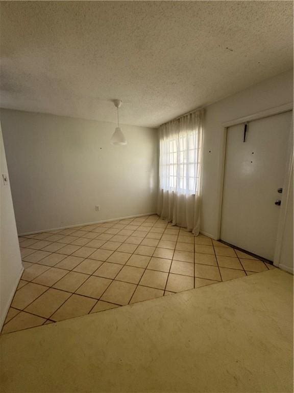 5 Vista Palm Ln Unit 105, Vero Beach, FL 32962 - unfurnished room featuring light tile patterned floors and a textured ceiling