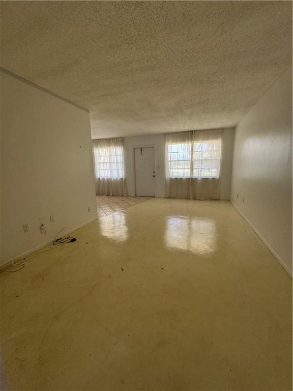 5 Vista Palm Ln Unit 105, Vero Beach, FL 32962 - empty room featuring a textured ceiling