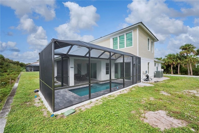 back of house featuring a lanai, central AC, and a lawn