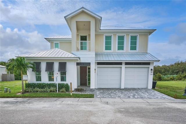 view of front of home with a front lawn and a garage