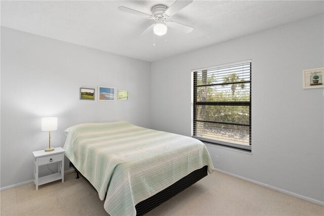 25 Plantation Dr Unit 206, Vero Beach, FL 32966 - bedroom with baseboards, light colored carpet, and ceiling fan