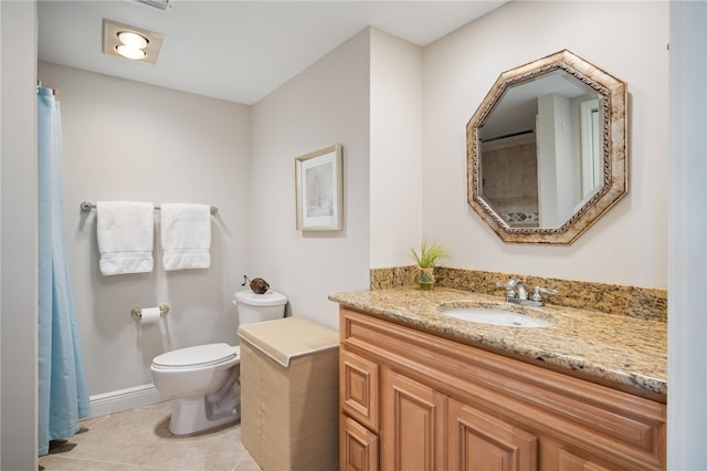 bathroom featuring tile patterned flooring, vanity, and toilet