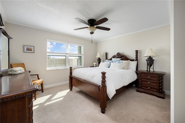 bedroom featuring light carpet, a textured ceiling, ceiling fan, and ornamental molding