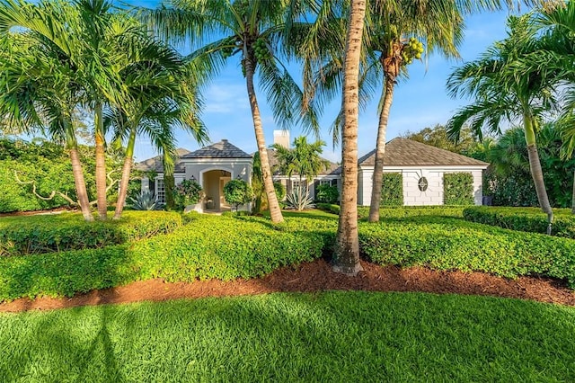 mediterranean / spanish-style house featuring a front yard