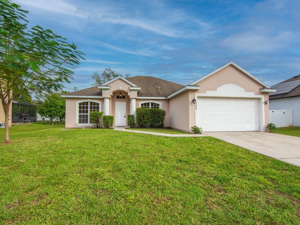 single story home with a front lawn and a garage