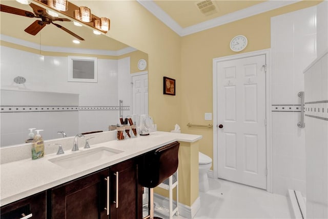 bathroom with toilet, vanity, ceiling fan, and ornamental molding