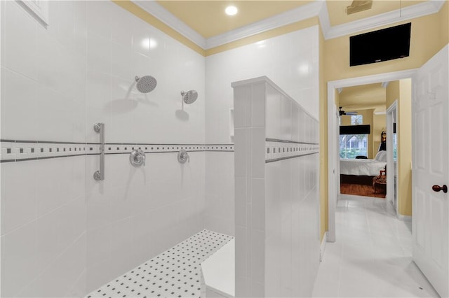 bathroom with crown molding, tile patterned floors, and a tile shower