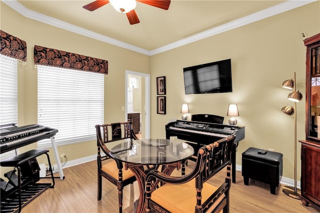 dining area with a healthy amount of sunlight, crown molding, light hardwood / wood-style floors, and ceiling fan