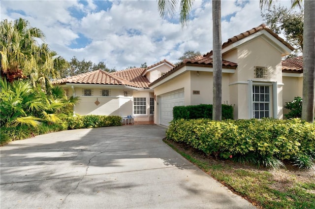 mediterranean / spanish-style home with a garage