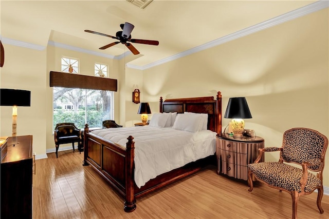 bedroom featuring light wood-type flooring, ceiling fan, and ornamental molding