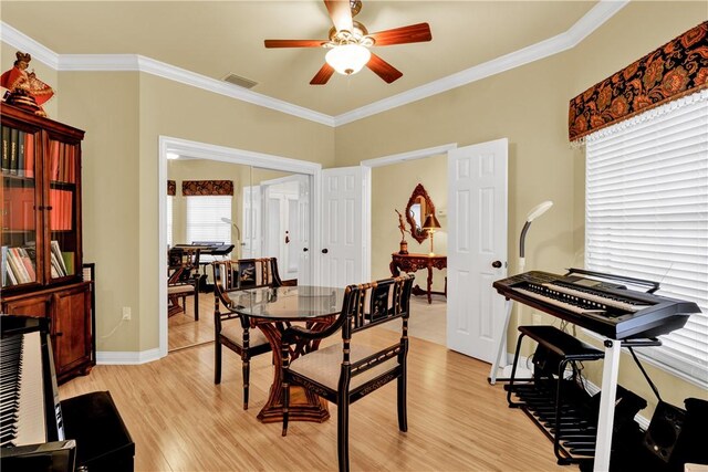 dining space featuring ceiling fan, ornamental molding, and light wood-type flooring