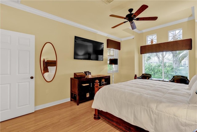 bedroom featuring ceiling fan, wood-type flooring, and ornamental molding