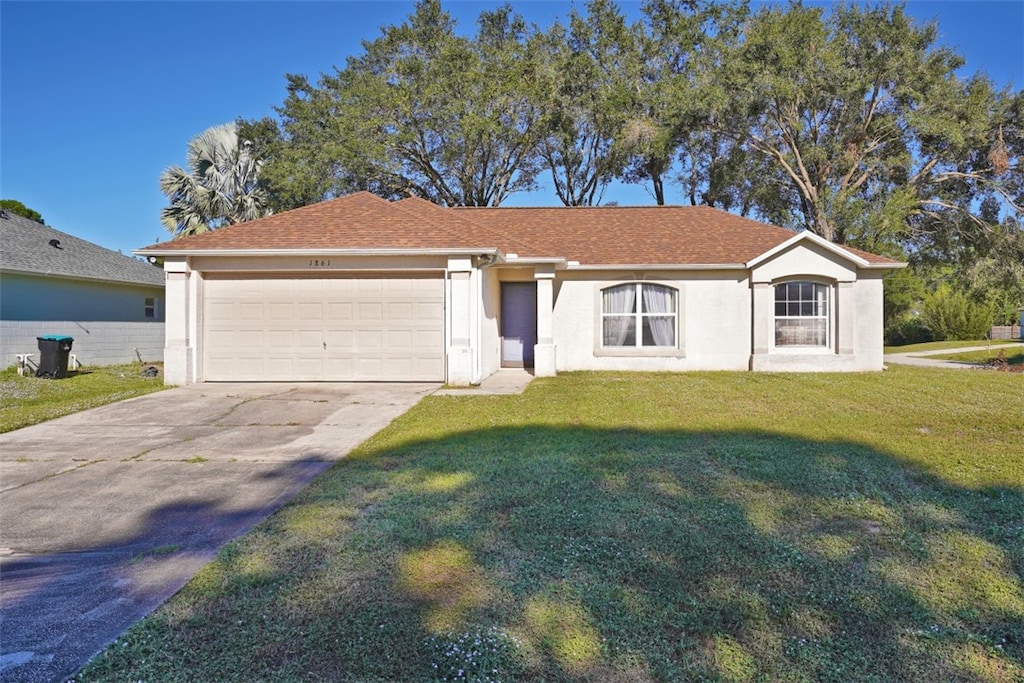 ranch-style house with a garage and a front lawn