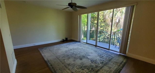 empty room with ceiling fan and dark hardwood / wood-style floors