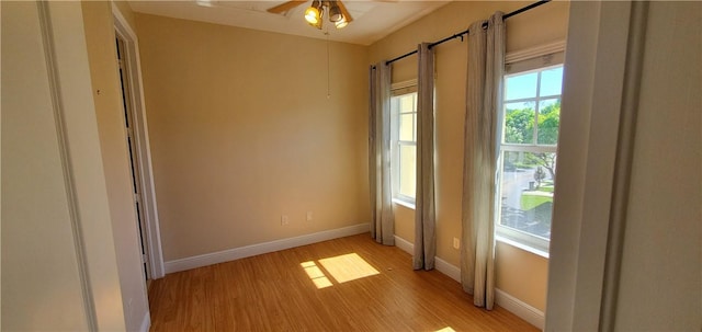 doorway featuring ceiling fan and light hardwood / wood-style floors