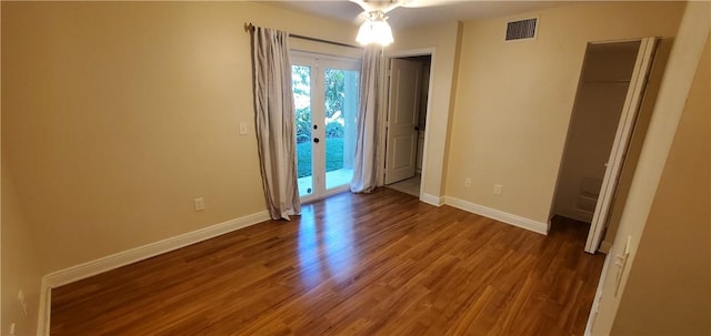 unfurnished room with french doors and dark wood-type flooring