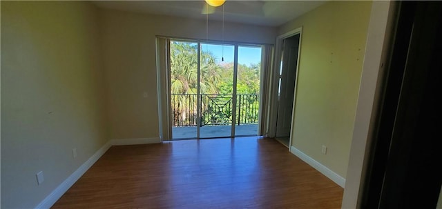 unfurnished room with ceiling fan and hardwood / wood-style flooring