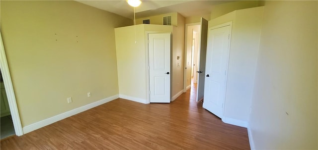 unfurnished bedroom with hardwood / wood-style floors