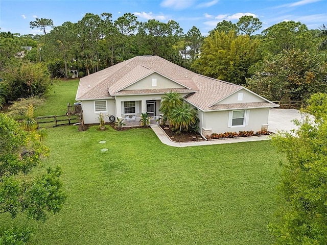 ranch-style house with a porch, fence, a front lawn, and stucco siding