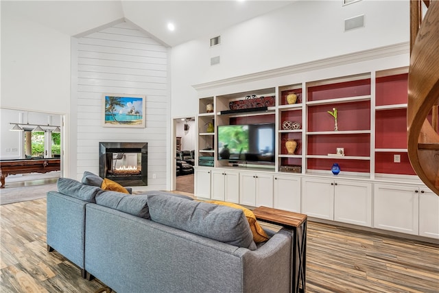 living room with high vaulted ceiling, pool table, a multi sided fireplace, and light hardwood / wood-style floors