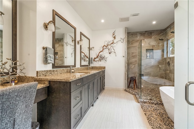 full bathroom featuring a soaking tub, visible vents, a shower stall, and vanity