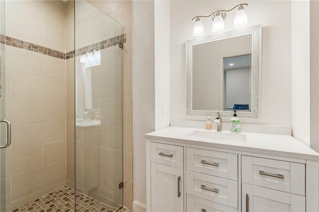 full bathroom with a shower stall and vanity