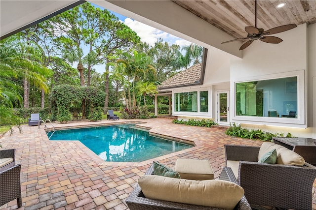 view of swimming pool with ceiling fan and a patio area