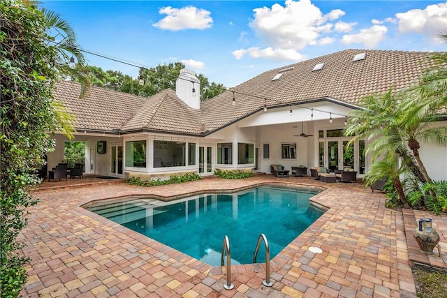 pool featuring ceiling fan, an outdoor hangout area, and a patio