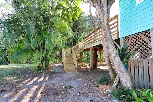 view of yard with stairway and fence