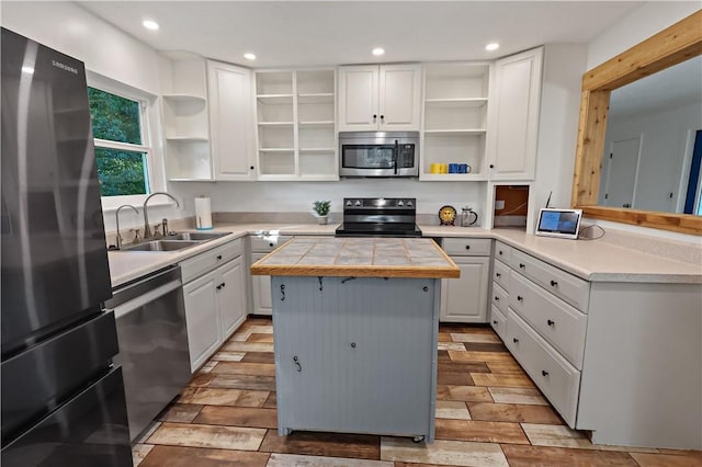 kitchen featuring white cabinetry, open shelves, and appliances with stainless steel finishes