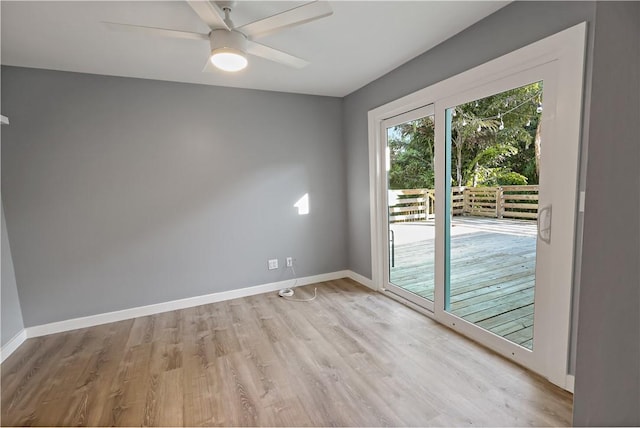 empty room with baseboards, light wood finished floors, and ceiling fan