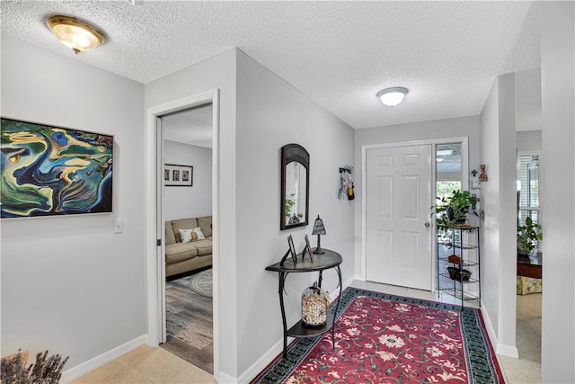 tiled entrance foyer with a textured ceiling