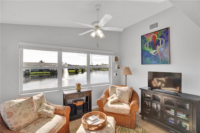 sitting room with light tile patterned flooring, ceiling fan, and vaulted ceiling