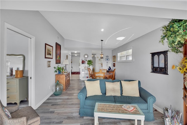 living room featuring hardwood / wood-style flooring and vaulted ceiling