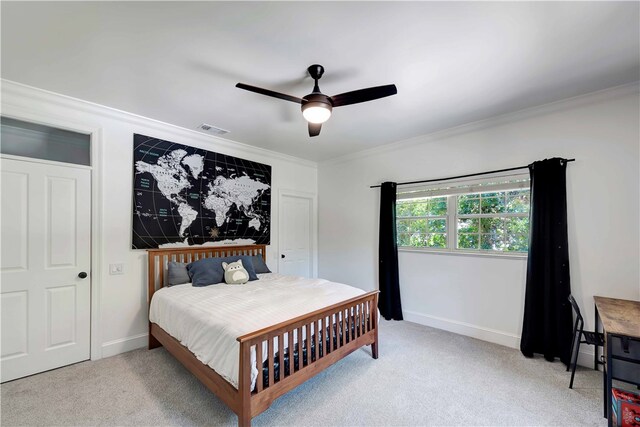 carpeted bedroom with ceiling fan and crown molding