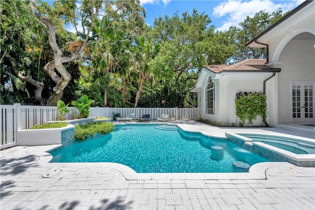 view of swimming pool with an in ground hot tub and a patio area