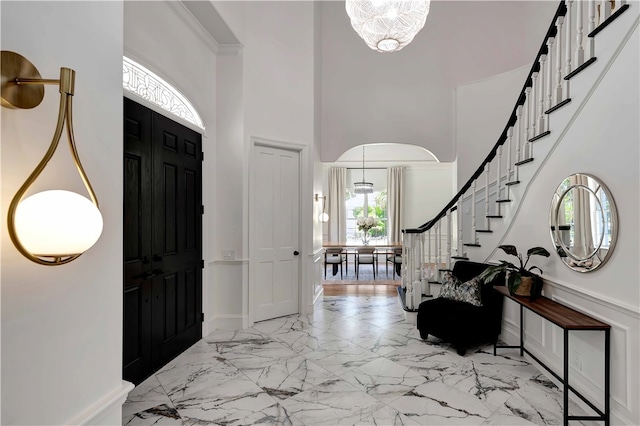 foyer featuring a high ceiling and a notable chandelier