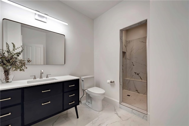 bathroom featuring toilet, vanity, and a tile shower