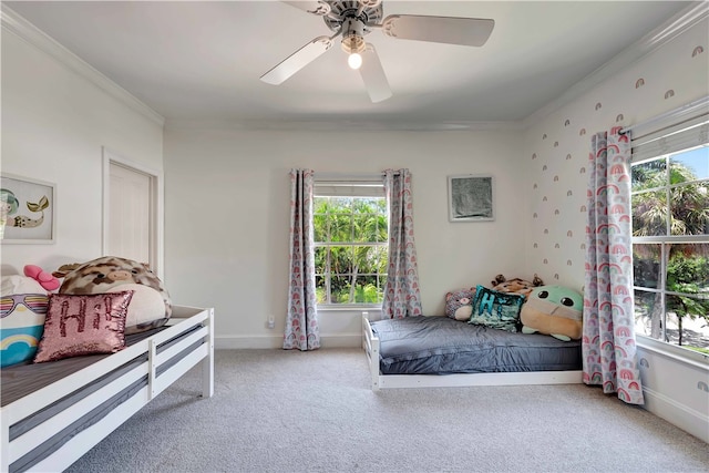 carpeted bedroom with ornamental molding, multiple windows, and ceiling fan