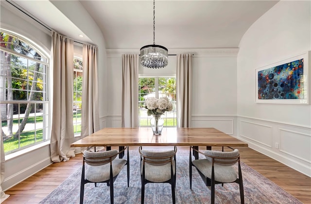 dining room featuring hardwood / wood-style floors, a notable chandelier, and plenty of natural light