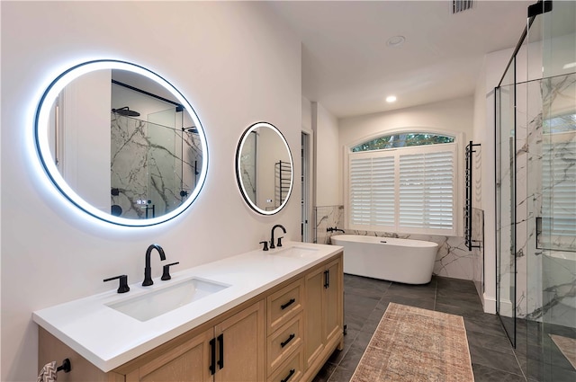 bathroom with tile patterned flooring, vanity, plus walk in shower, and tile walls