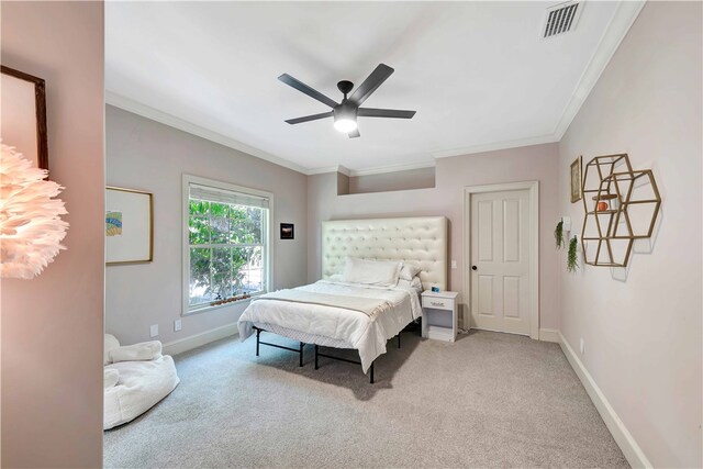 bedroom with carpet, ceiling fan, and crown molding