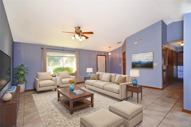 tiled living room with ceiling fan and vaulted ceiling