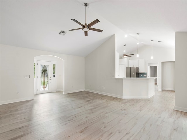 unfurnished living room featuring high vaulted ceiling, light hardwood / wood-style flooring, and ceiling fan